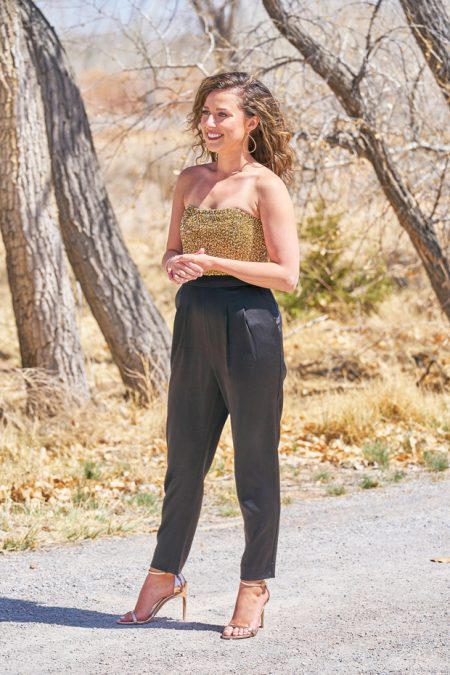 Katie is wearing a gold or olive green beaded corset and pleated leather pants and its not great