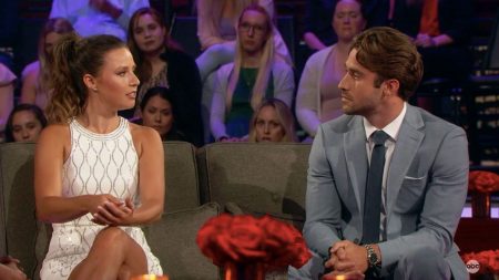 Katie and Greg sit on opposite ends of a sofa