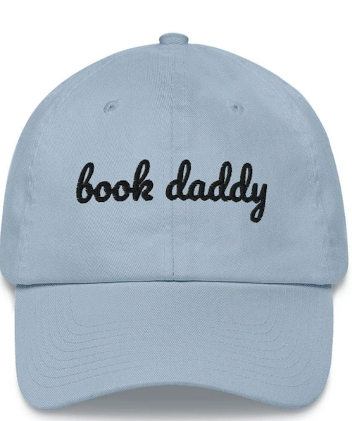 A blue cap that says in lowercase script book daddy