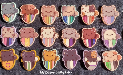 Cats atop striped hearts representing different sexualities and identities