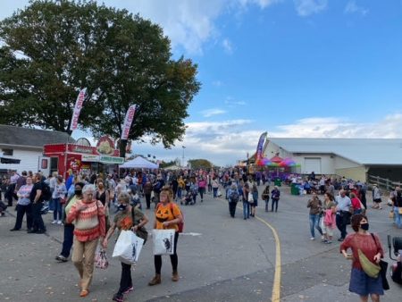 A crowd of people walking on the fairgrounds