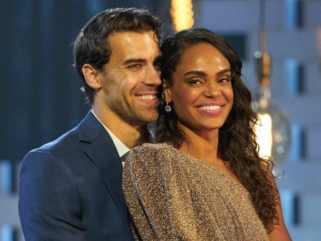 Rick stands behind Michelle, hugging her