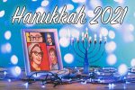 Hanukkah 2021 with a framed picture of SBTB's original ladies and a lit menorah