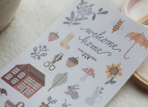 A close up of stickers made to look like cross stitch home motifs