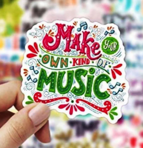 A close up of a sticker that says Make Your Own Kind of Music with red and green accents
