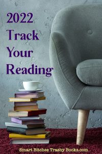 2022 Track Your Reading - a blue felt chair with a stack of books on the floor with a cup of tea on top 