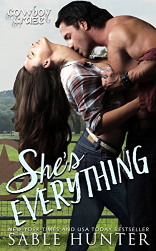 She's Everything by Sable Hunter. This cover is front of a livestock pasture with a fence. A shirtless man is ripping open a woman's plaid button-down shirt as she bends backward. He's kissing her neck and their chests are pressed together.