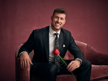 Clayton smiles holding a rose