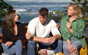 Clayton sits between the women and looks at his feet