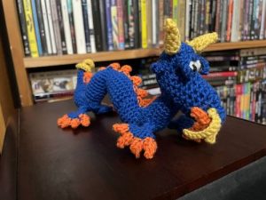 a bright blue crochet dragon crocheted by catherine 