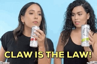 two women toast white claw and say the claw is the law