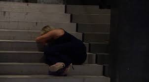 Rachel cries on the stairs