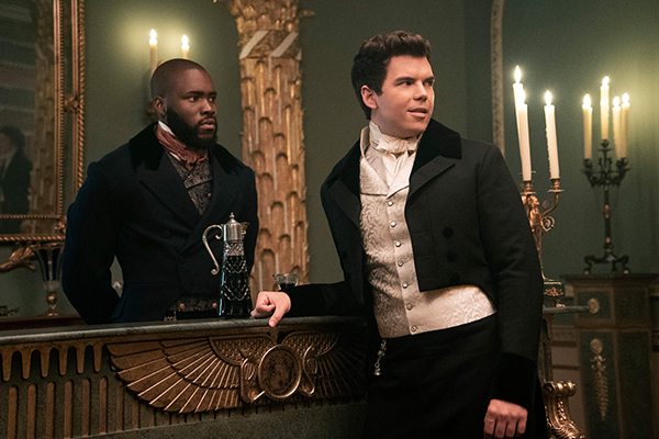 Martin Imhangbe and Luke Newton from Bridgerton; Luke Colin is standing at a bar looking like he's about to find someone to ignore