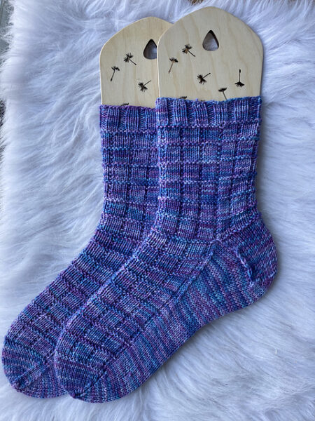 A pair of blue and purple socks with a waffle knit pattern