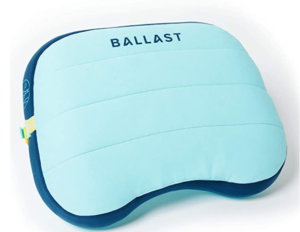 An inflatable light blue beach pillow with the world ballast on the top and a slight cut out for your neck 