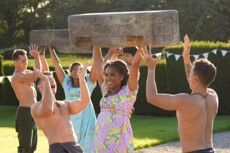 Nicole holds a log over her head