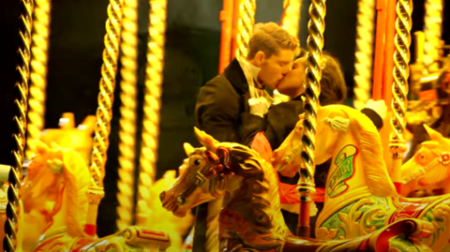 Nicole kisses Mr. Chapman on the carousel