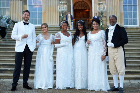 Nicole, her court and the host stand in front of the castle