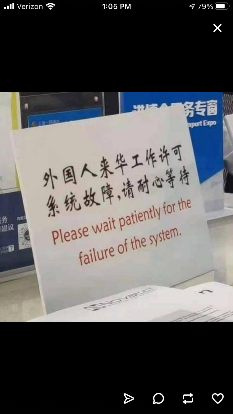 A sign in I believe hapanese that reads Please wait patiently for the failure of the system 