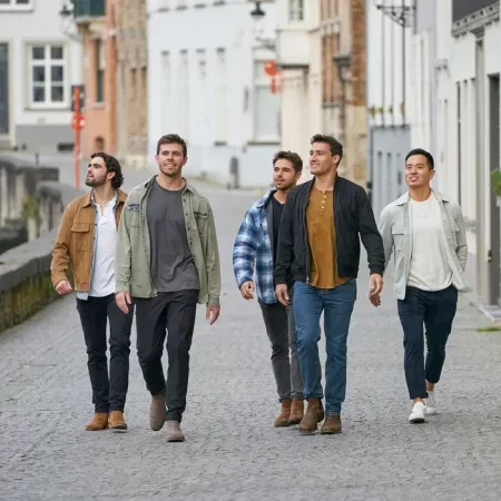 Rachel's dudes walk down the street in Bruges