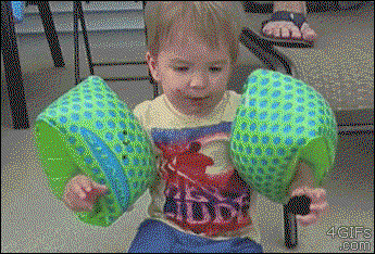 a kid chews on his floaties