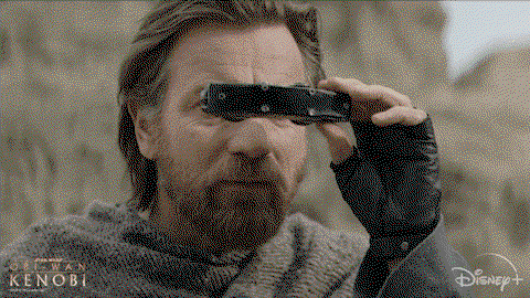 ewan macgregor as bearded hot Obi Wan looking through wee space binoculars to inspect something
