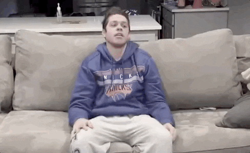 Pete Davidson slouches down on a couch