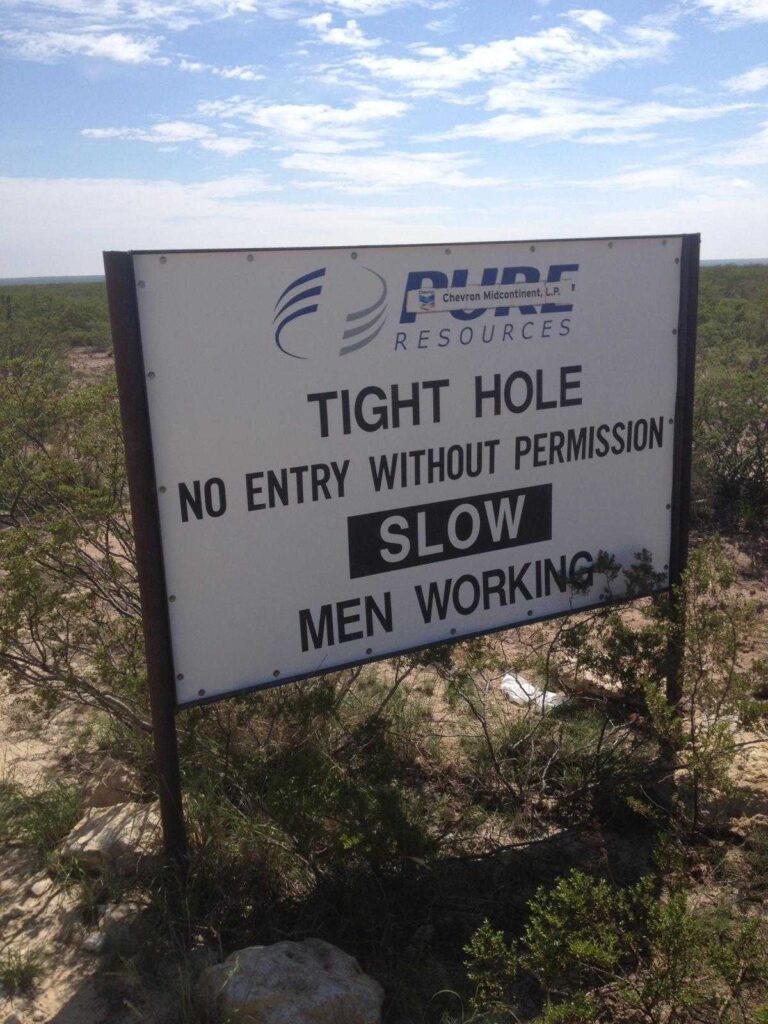 A construction sign that reads "tight hole, no entry without permission"
