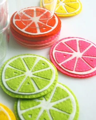 citrus fruit slice coasters in pink, orange, green and yellow