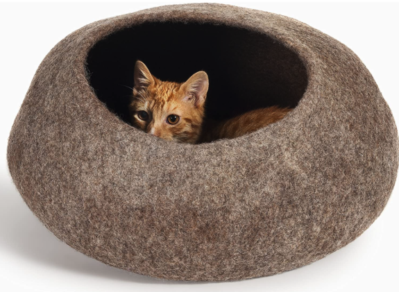 A felt cat cave with a cat peeking out 