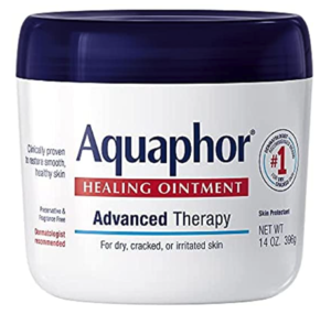 Aquaphor tub with a white bottle and a dark blue lid