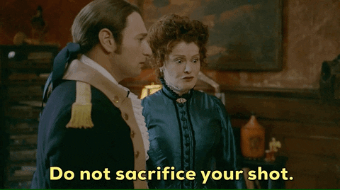 Two ghosts on CBS's GHOSTS talking and the woman in an antique gown says Do Not Sacrifice your Shot!