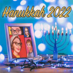 Hanukkah 2022 in yellow above a framed picture of the original ladies and a menorah surroudned by blue and white lights