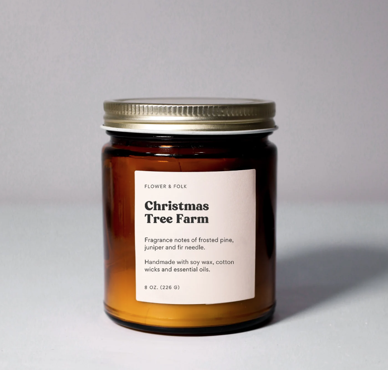 Christmas Tree Farm candle. A white candle in an amber jar with a metal screw on lid.