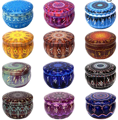 A set of 12 candles in various jewel tone colors with lids 