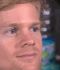 a man blinks and shakes his head 