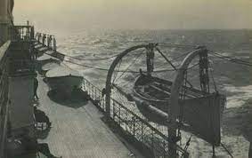 photo of empty lifeboats hanging over the deck