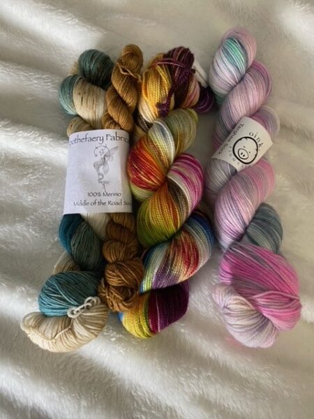 Three skeins of yarn on a white background