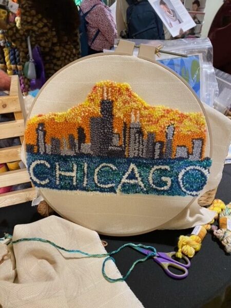 An embroidery project made with yarn. It says Chicago beneath the image of the Chicago skyline. 