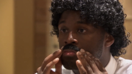 Nehemiah glues on a mustache