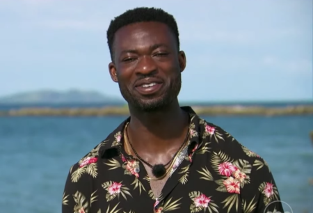 Dotun smiles with the ocean in the background