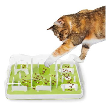 A green puzzle toy with flaps and holes int he top with food inside for cats to try to grab