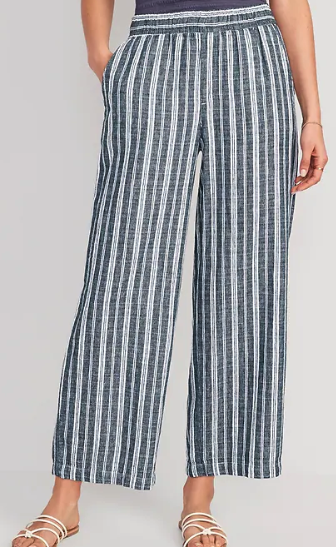 Blue and white striped linen blend pants worn by a white model wearing tan sandals
