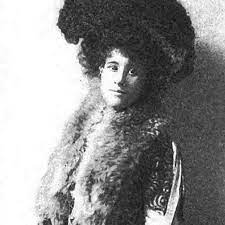 Winnifred Eaton in an enormous feathered hat and fur collar