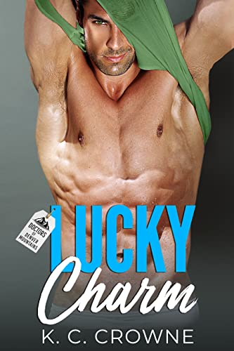 Lucky Charm by K.C. Crowne. A man appears tangled in his green tank top while trying to take it off, causing his abs to flex very tightly. The background is also the same shade of green as his tank top.