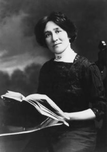 Black and white photo of Edith Maude Eaton holding a book