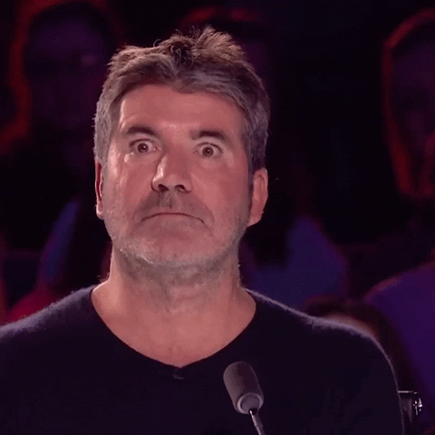 Simon Cowell looks worried and has big eyes