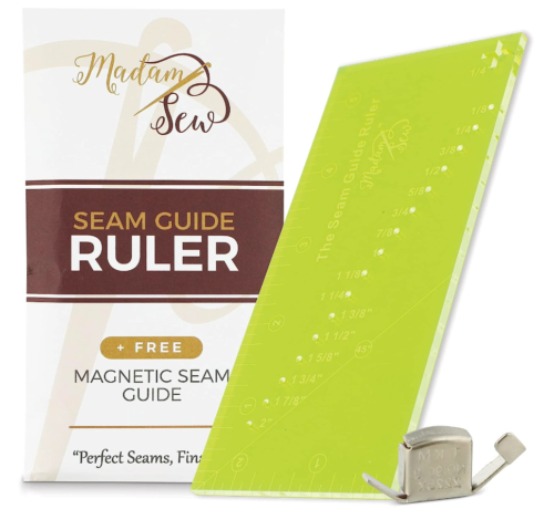Madam Sew Seam Allowance Ruler and Magnetic Seam Guide, a tiny metal box that has a magnet beneath to grab onto the stitchplate of the sewing machine. it has a bumper that helps guide the fabric toward the presser foot to maintain seam allowance