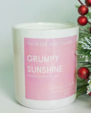 Grumpy Sunshine Candle on a pink label with white candle beneath