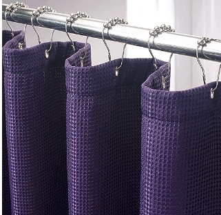  A purple waffle weave shower curtain on silver shower curtain rings 